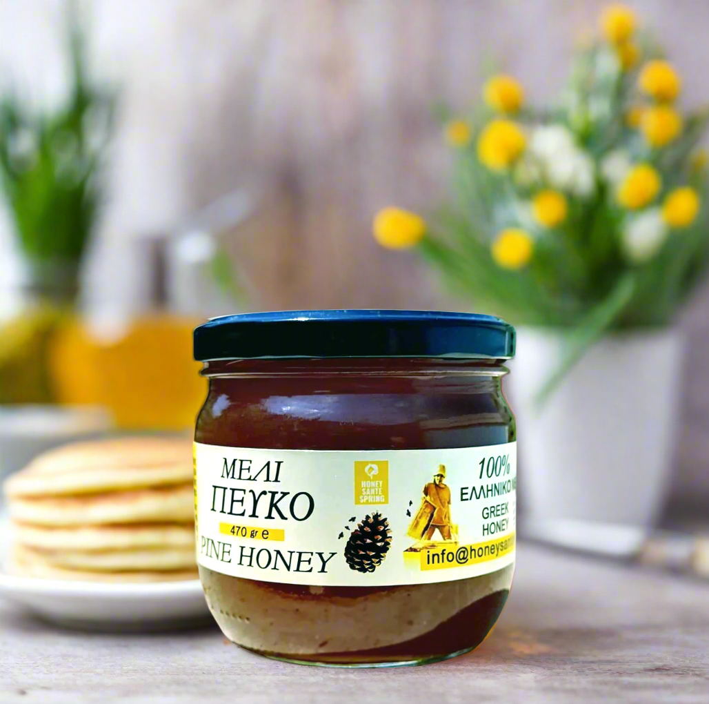 Jar of pine honey on a table with pancakes and flowers